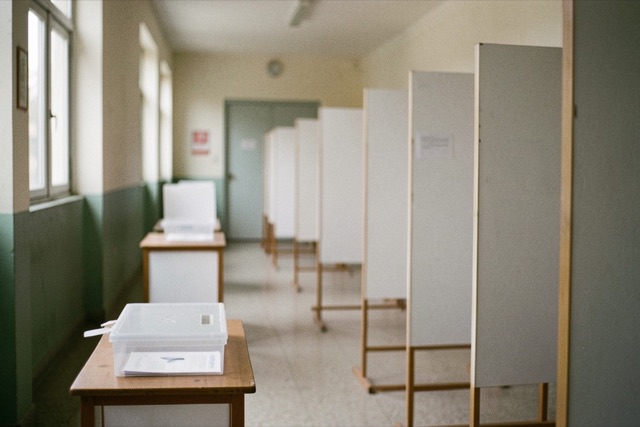 Unmarked ballot boxes and voting booths in an empty school corridor