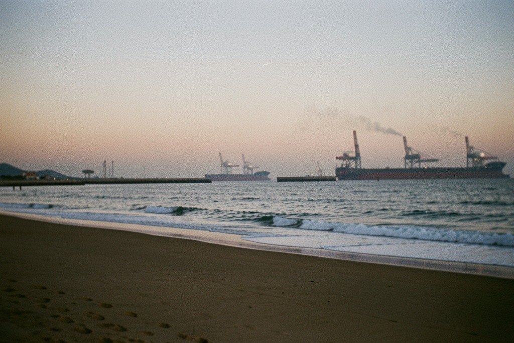 Río Negro coastline with distant offshore infrastructure silhouettes
