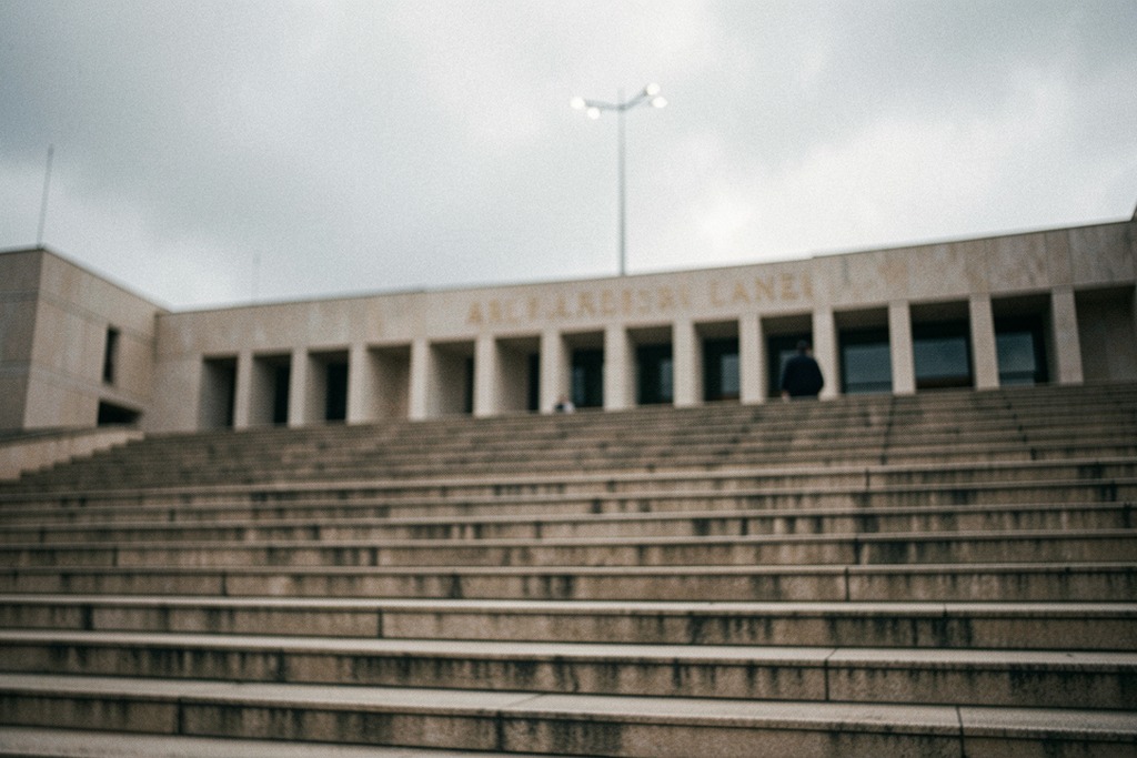 Steps outside a legislative chamber on a cloudy day