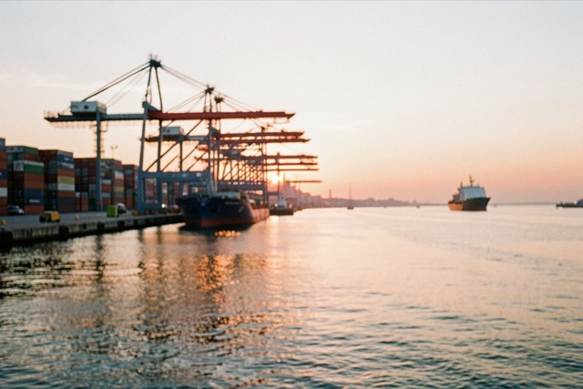 Port cranes and a ship in a Buenos Aires harbour at sunrise